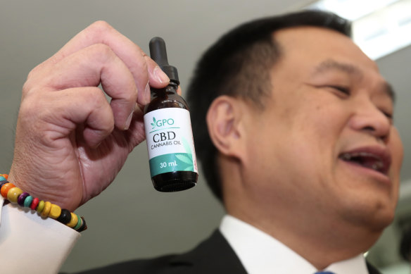Thailand’s Public Health Minister Anutin Chanvirakul shows off a bottle of extracted cannabis oil.