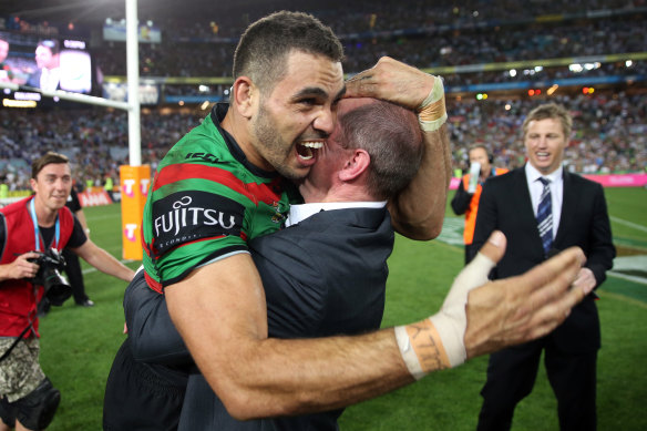 Greg Inglis and Michael Maguire share a moment after South Sydney’s 2014 grand final triumph.