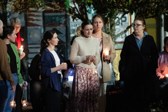 Sophie Roome is comforted by family, friends and the community of Lismore at a silent vigil for Rowan, 2, who was murdered by his father last Sunday.