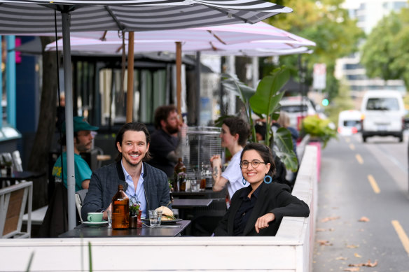 Yarra mayor Gabrielle de Vietri and Gertrude Street resident Peter ‘PK’ Kaylor make use of the parklets at Archie’s All Day cafe on Monday afternoon.