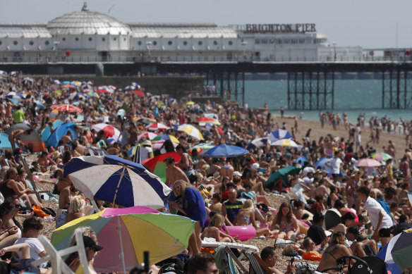 Beachgoers flocked to Brighton Beach as Britain recorded its highest temperatures on record this week.