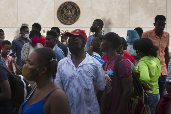 Haitians outside the U.S. Embassy  amid rumors on radio and social media that the US will be handing out exile and humanitarian visas. 