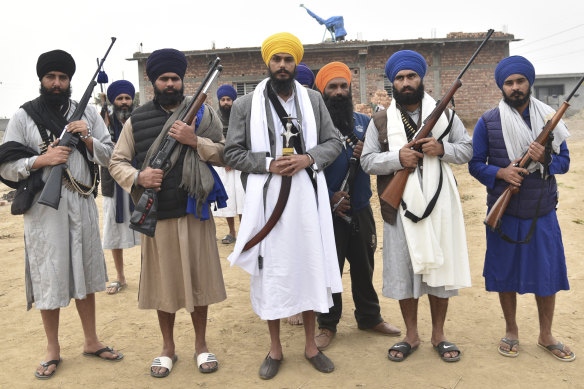 Amritpal Singh, Sikh separatist leader and head of Waris Punjab De, or Punjab’s Heirs stands (centre in yellow turban) with supporters in the village of Jallupur Khera.