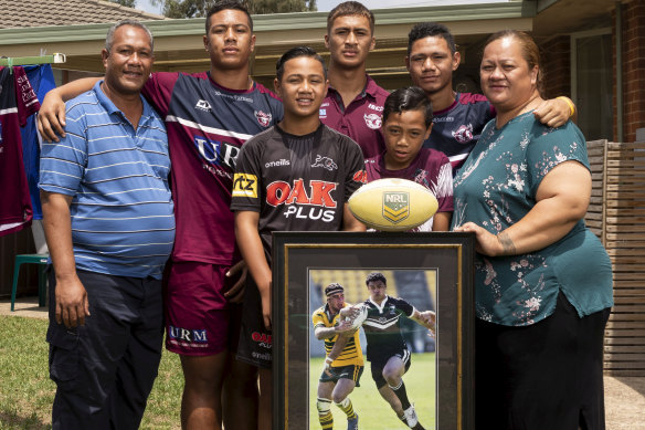 Legacy: Members of the Tupulua Fai household, from left, Tupulua, Zechariah, Zhaoquin,  Zhivargo, Sonny, Zedrick and Lyndah, with a framed photo of former Warriors star Sonny Fai (above).