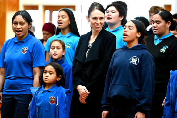 New Zealand Prime Minister Jacinda Ardern stands with students from Te Wharekura o Manurewa school as they perform ahead of receiving her first COVID-19 Pfizer dose on Friday.