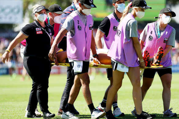 Erica Fowler is stretchered off the field. 