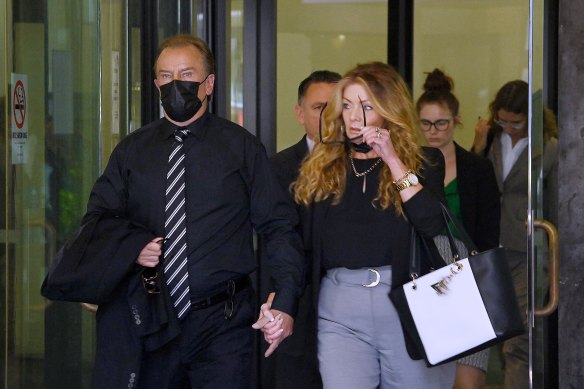 Complainant Brett Sengstock,  accompanied by his partner, leaves the Downing Centre courts on Monday.