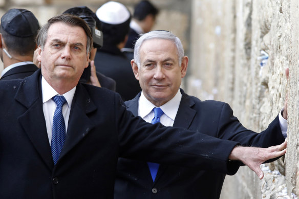 Brazilian President Jair Bolsonaro (left) and Israeli Prime Minister Benjamin Netanyahu touch the Western wall, the holiest site where Jews can pray, in the Old City of Jerusalem, in April this year.