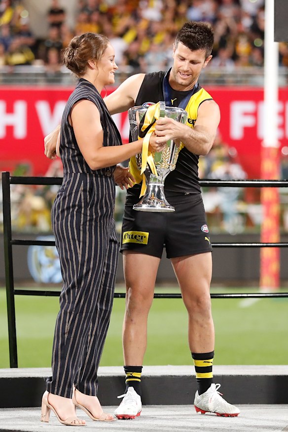 Ash Barty presents the 2020 AFL premiership cup to Trent Cotchin in Brisbane.