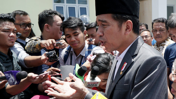 Joko "Jokowi" Widodo speaks to journalists at an Islamic microfinance bank in Balaraja, Banten province.