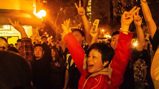 Local residents celebrate as Junius Ho Kwan-yiu loses in District Council Elections, outside a polling station in Hong Kong, 