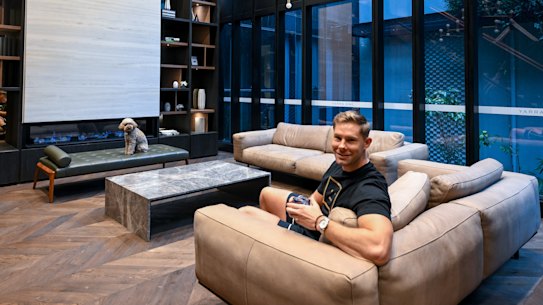 Nathan Rhodes, with his dog Lily, at the communal lounge in the Yarra One building.