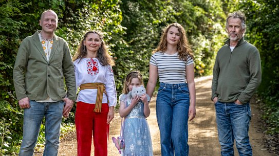 Chemical engineer Mark Corrigan (right) and his neighbours Tetiana and Oleksandr Tkachuk, with daughters Sophia and Maria.  