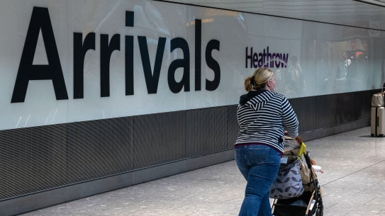 A passenger in the arrivals hall of Terminal 5 at London Heathrow Airport in London. The UK government wants to slash immigration levels.