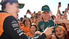 Oscar Piastri of Australia and McLaren signs autographs ahead of practice on Friday.