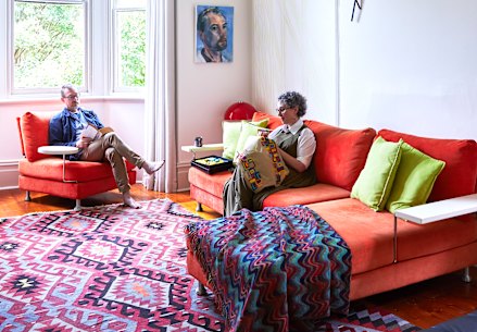Chris Packer and Selina Samuels in the formal living room in the old part of their house, where vintage features are offset by modern furniture, light fittings and Packer’s contemporary artworks.
