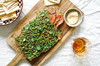 A final flourish of herbs and peppercorns can be added to the salmon gravlax before serving.