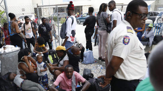 Haitians waiting to board a flight to Nicaragua gather after the government banned all charter flights to Nicaragua, at Toussaint Louverture International Airport in Port-au-Prince, Haiti.