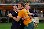  Harry Wilson of the Wallabies celebrates with Phil and Charlie Waugh.