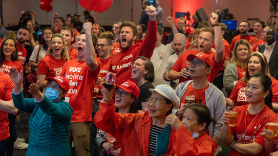 Labor Party supporters cheer after the ABC projects an ALP win on November 26.