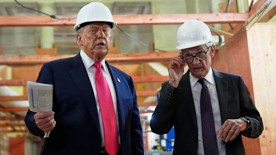 Donald Trump discusses renovation work with Fed chair Jerome Powell in July.
