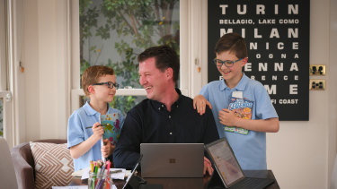 Officeworks general manager finance Justin McKernan (with sons Hamish, left, and William), has enjoyed the extra time with family while working from home.