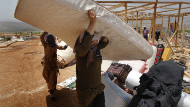 Syrian refugees being evacuated from the Deir Al-Ahmar camp in eastern Lebanon.