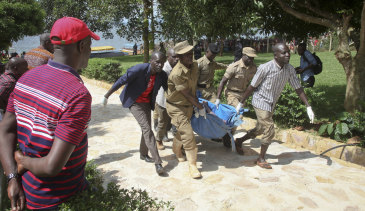 Rescue workers carry a body recovered from Lake Victoria on Sunday.
