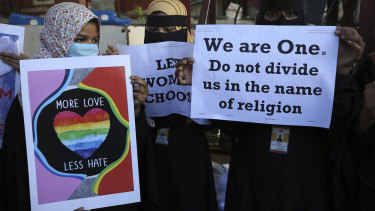 Indian Muslim women hold placards denouncing the new interfaith marriage law in Uttar Pradesh, during a protest in Bengaluru, India.