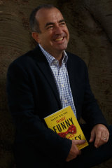 Comedian and author Marty Wilson with his book, More Funny More Money.