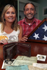 Sharon McCusker Moore and her brother Steven McCusker pose with their father's long lost wallet and its contents in Dover, New Hampshire.