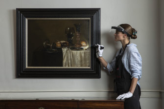 Senior paintings conservator Claire Heasman inspects the painting, confirmed to be a Dutch Master from the 17th century during restoration. 