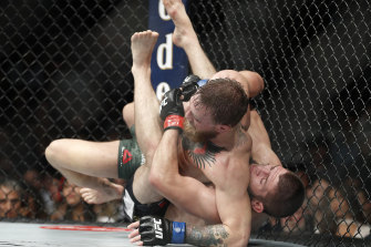 Khabib Nurmagomedov, right, takes down Conor McGregor during the UFC bout that was illegally advertised by Tabcorp.