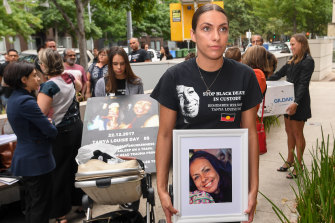 Daughters Apryl Watson and Kimberly Watson with photos of their mother Tanya Day outside Coroners Court.