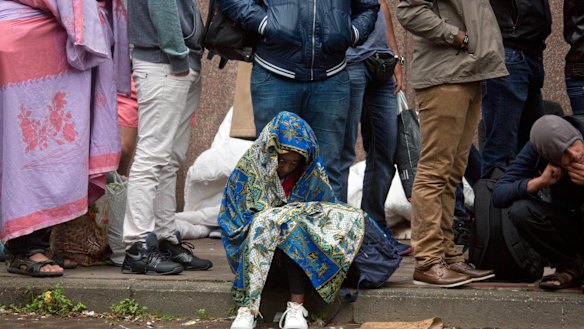 A young child waits in line at a migrant reception center in Brussels. Belgian migration minister Theo Francken said he wants no part of a United Nations pact on safe and orderly migration.