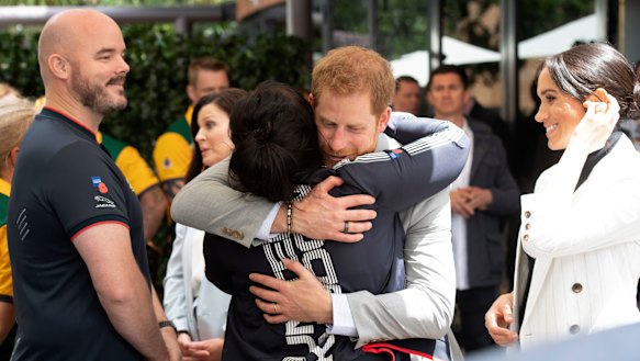Hug it out ... Despite criticism, Harry and Meghan have shown a softer, more affectionate side of royal life.