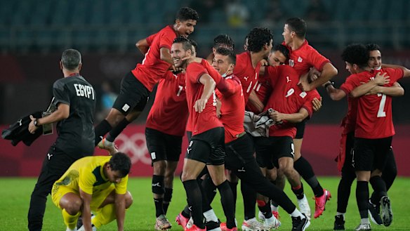 Egypt’s players celebrate their 2-0 victory over Australia.