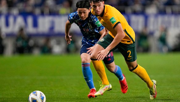 Australia’s Fran Karacic, right, and Japan’s Takumi Minamino battle for the ball.