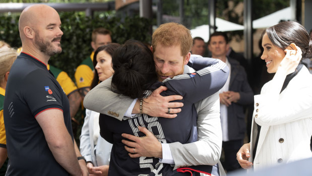 Hug it out ... Despite criticism, Harry and Meghan have shown a softer, more affectionate side of royal life.