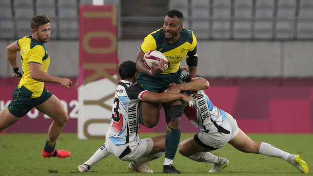 Australia’s Samu Kerevi is tackled by Korean opponents.