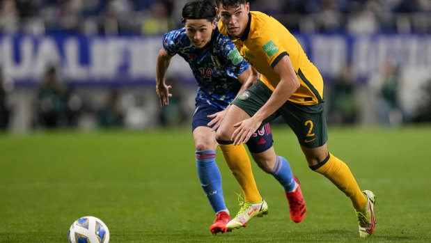 Australia’s Fran Karacic, right, and Japan’s Takumi Minamino battle for the ball.