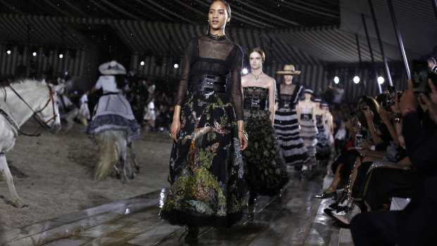 Models wear creations for Dior's Cruise 2019 fashion collection in Chantilly, north of Paris.