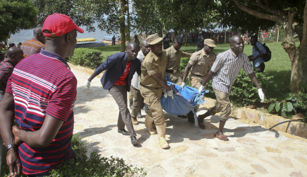 Rescue workers carry a body recovered from Lake Victoria on Sunday.