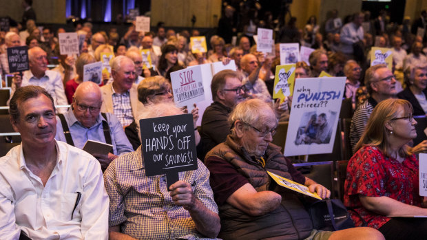 Opponents to Labor's dividend imputation policy change at a recent protest. Bank valuations could be sliced by up to 13 per cent.