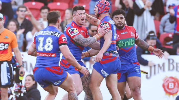 The Knights celebrate another Kalyn Ponga try.