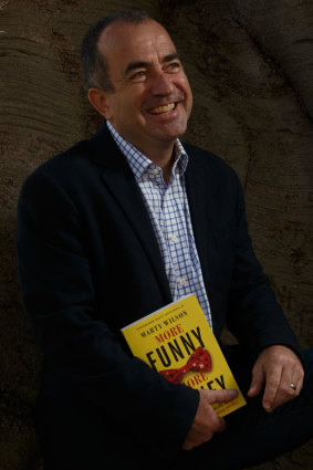 Comedian and author Marty Wilson with his book, More Funny More Money.