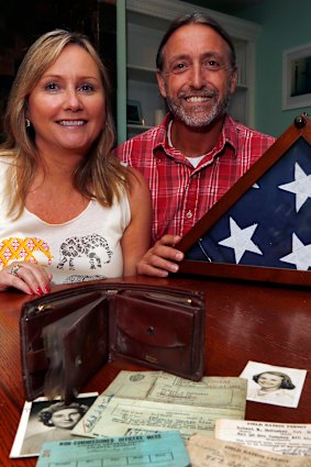 Sharon McCusker Moore and her brother Steven McCusker pose with their father's long lost wallet and its contents in Dover, New Hampshire.