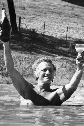 Clifton Pugh celebrates his Archibald Prize win with champagne in the dam at his Cottlesbridge home 