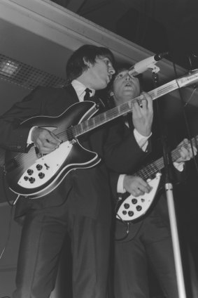 George Harrison and John Lennon perform in Melbourne in 1964.