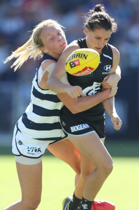 Gabriella Pound gets a firm grip on her Geelong opponent.